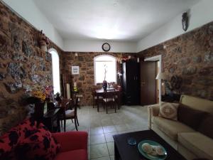 a living room with a couch and a table at Accommodation in Lithi in Chios