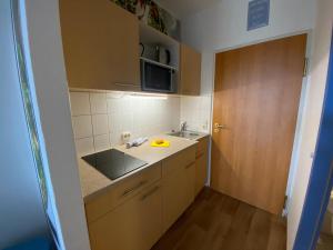 a small kitchen with a sink and a counter at #Steuerbord# direkt an der Ostsee in Schönberg