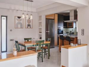 a kitchen and dining room with a table and chairs at Ethirenia in Karistos