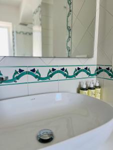 a bathroom with a white sink and a mirror at B&B L'Agapanto in Capri