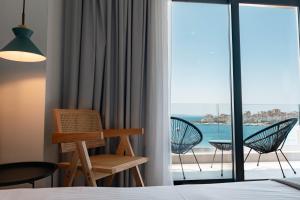a hotel room with a view of the ocean at Kanes Boutique Hotel in Sarandë