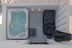 an inside view of a small room with a suitcase at Esperos Premium suites in Naxos Chora