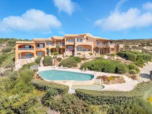 an aerial view of a house with a swimming pool at Villaggio Sherden - Maison & Relais Apartments in Golfo Aranci