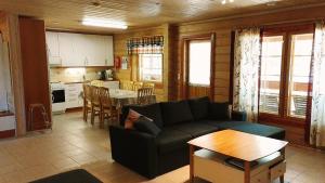 a living room with a couch and a table at Lomavouti Cottages in Savonranta