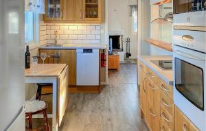 a kitchen with white appliances and a counter top at Holiday Home Mörtekull Torup in Torup