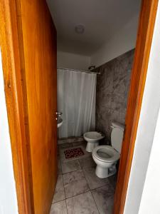 a bathroom with a toilet and a sink at Don Benja in Federación +19 photos