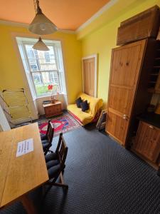a room with a table and chairs and a bedroom at City centre Flat - sleep upto 4 in Edinburgh