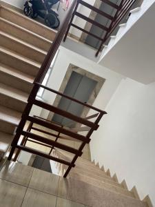 a staircase in a building with wooden railings at Luxury apartment 2 in Pogradec