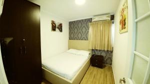 a small bedroom with a bed and a window at City Apartments in Eilat +139 photos