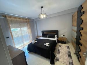 a bedroom with a bed with two towels on it at Luxury apartment 2 in Pogradec