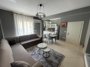 a living room with a couch and a table at Luxury apartment 2 in Pogradec