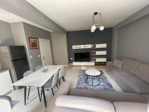 a living room with a couch and a table at Luxury apartment 2 in Pogradec