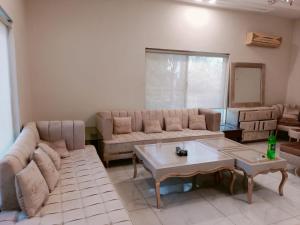 a living room with a couch and a table at Baagh-e-sakoon in Islamabad