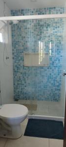 a bathroom with a toilet and a blue tiled shower at Loft Aconchegante em Petrópolis in Petrópolis +22 photos