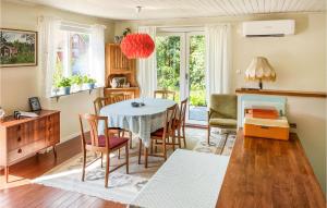 a kitchen and dining room with a table and chairs at 2 Bedroom Beautiful Home In Löderup in Löderup