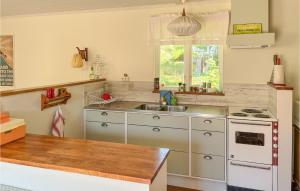 a kitchen with a sink and a stove at 2 Bedroom Beautiful Home In Löderup in Löderup