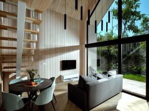 a living room with a couch and a table at Baltico Stodoła in Mielno