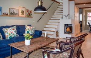 a living room with a blue couch and a table at 2 Bedroom Lovely Home In Ystad in Ystad