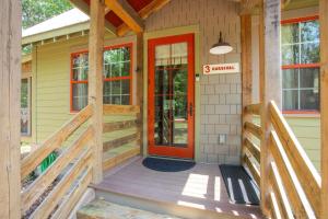 a front porch of a house with a red door at The Cardinal at Buckhorn Hollow in McEwen +22 photos