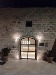 an entrance to a brick wall with a door at Borgo Don Ciccio Dimora Storica in Felline