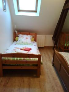 a small bedroom with a bed with a window at Gite De Malvoue in Vimoutiers