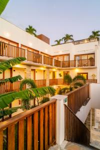 a building with wooden railings and palm trees at Aiolos Hotel & Discoveries in Prea
