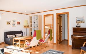 a living room with a table and chairs and a piano at Cozy Home In Ålem With Kitchen in Ålem