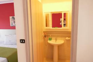 a bathroom with a sink and a mirror at Agriturismo Aiolia al mare in Patti