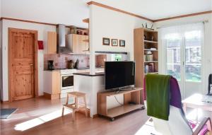 a living room with a television and a kitchen at Cozy Home In Ålem With Kitchen in Ålem