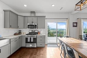 a kitchen with a table and a stove top oven at 838B Wapiti Dr in Fraser