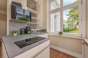 eine Küche mit Spüle und Fenster in der Unterkunft Villa Carmen Strandperle in Ahlbeck