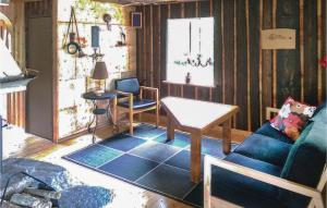 a living room with a blue couch and chairs at 3 Bedroom Cozy Home In Åmål in Åmål