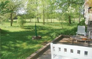 a patio with a table and a white bench at Holiday Home Bön Granbacken Brålanda in Sörbo