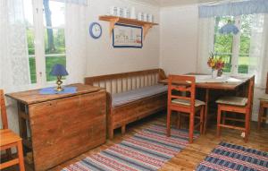 a room with a bench and a table and a desk at Holiday Home Bön Granbacken Brålanda in Sörbo +10 photos