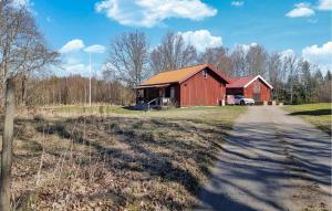 a red barn on the side of a road at Amazing Home In Hindås With Wifi in Hindås