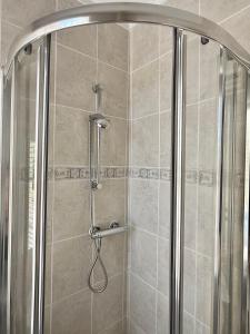 a shower with a glass door in a bathroom at Entire Apartment by City Centre & Harbourside in Bristol