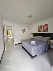 a bedroom with a bed in a white room at Ecoparadise Flat 103 in Caucaia +9 photos