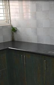 a kitchen with a black counter top and a sink at Luxos by Proximus in Bengaluru +13 photos