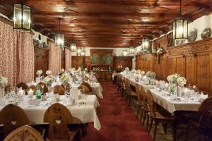 a large room with tables and chairs with white table cloth at Isserwirt in Innsbruck