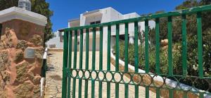 a green gate in front of a house at Villa Can Kiko Ibiza in San Jose