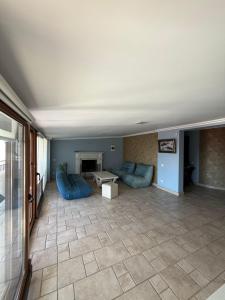 a living room with blue couches and a fireplace at Sunny Side in Batumi