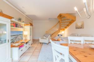 a dining room and living room with a table and chairs at Ferienhaus Josephin in Boltenhagen