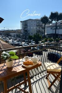 a table with a plate of food on a balcony at Zeta Boutique in Caserta