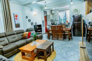 a living room with a couch and a table at Bellevie Homestays in Uru