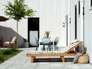 a patio with a table and chairs on a patio at Baltico Stodoła in Mielno