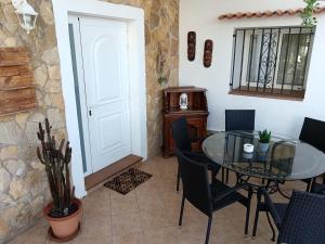 a dining room with a glass table and chairs at Casa Susana in Santa Eularia des Riu