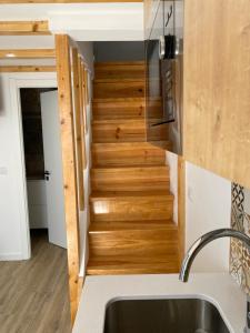 a staircase in a tiny house with a sink at Castle House in Palmela