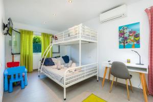 ein Kinderschlafzimmer mit einem Etagenbett und einem Schreibtisch in der Unterkunft Llevantpicafort in Santa Margalida + 22 Fotos