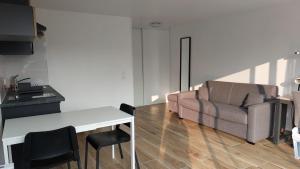 a living room with a couch and a chair at La Loge du Capitole in Veyrier-du-Lac