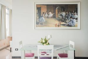 a dining room with a painting on the wall at The Lodge Salento - San Foca in San Foca